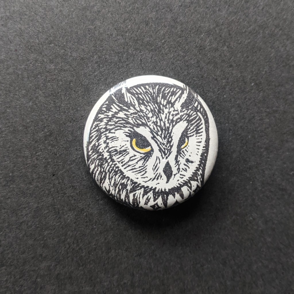 a pinback button of a stamped long eared owl
