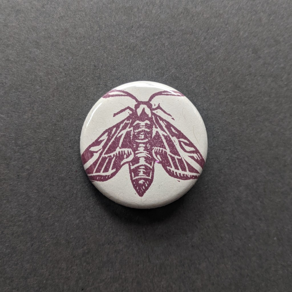 a button of a stamped tiger moth