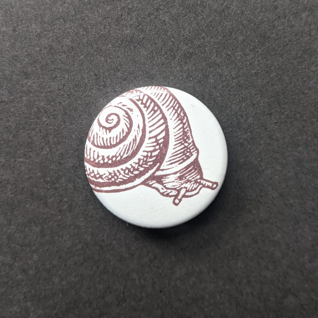 a button of a stamped snail