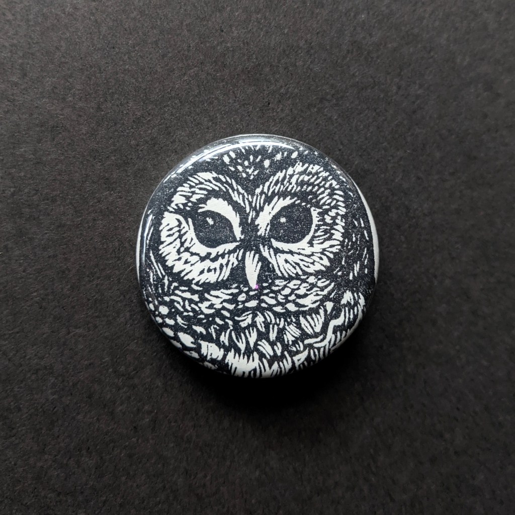 a stamped button of a spotted owl