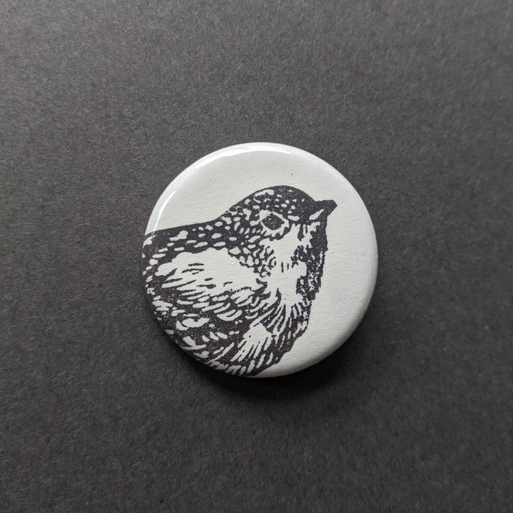 a stamped button of a wren