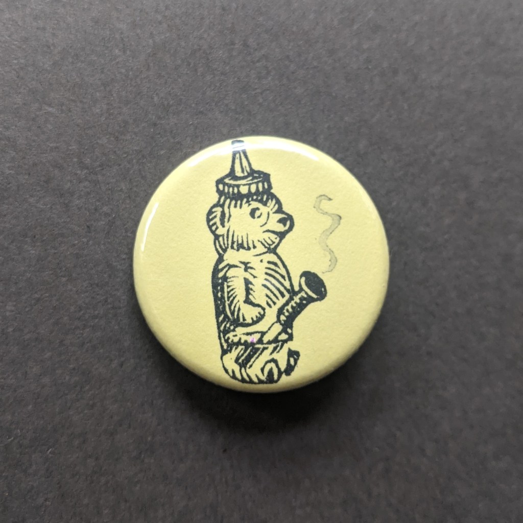a button stamped with a honey bear bong