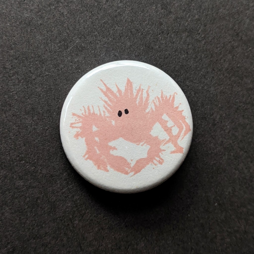 stamped button of a baby king crab